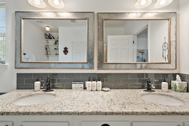 415 Angel Fire Rd, Dripping Springs, TX 78620 - bathroom with tasteful backsplash and double vanity