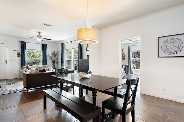 415 Angel Fire Rd, Dripping Springs, TX 78620 - dining space with ceiling fan, ornamental molding, tile patterned floors, and baseboards