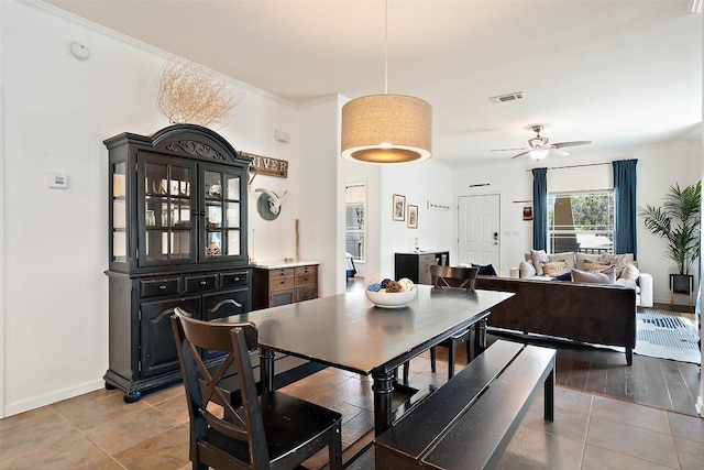 415 Angel Fire Rd, Dripping Springs, TX 78620 - dining room with a ceiling fan, baseboards, light tile patterned floors, and crown molding