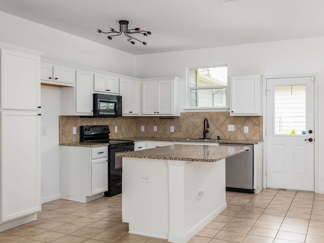 402 Crater Lake Dr, Pflugerville, TX 78660 - kitchen with black appliances, white cabinetry, decorative backsplash, and dark stone countertops