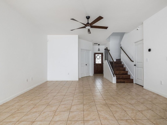 402 Crater Lake Dr, Pflugerville, TX 78660 - unfurnished living room with a ceiling fan, stairs, light tile patterned floors, baseboards, and lofted ceiling