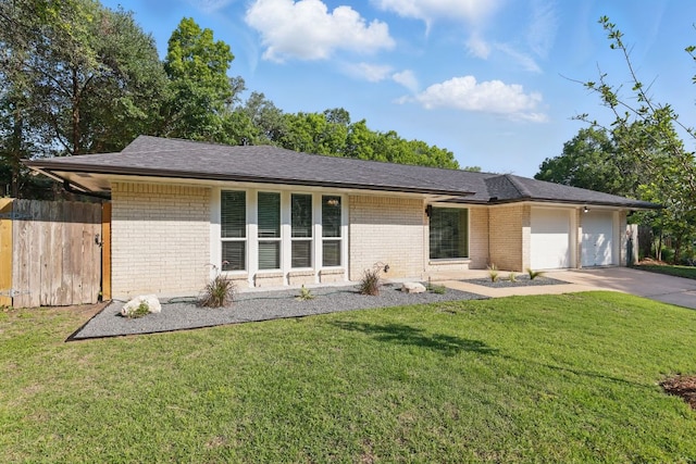 8506 Shenandoah Dr, Austin, TX 78753 - view of front of house with brick siding, an attached garage, driveway, and roof with shingles