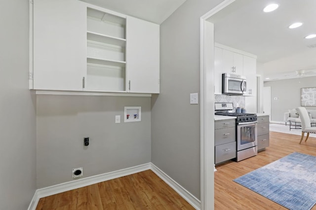 8506 Shenandoah Dr, Austin, TX 78753 - laundry room featuring electric dryer hookup, hookup for a washing machine, light wood-style floors, baseboards, and recessed lighting