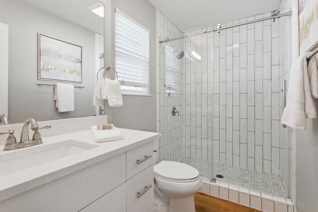 8506 Shenandoah Dr, Austin, TX 78753 - full bath featuring a shower stall, vanity, toilet, and wood finished floors