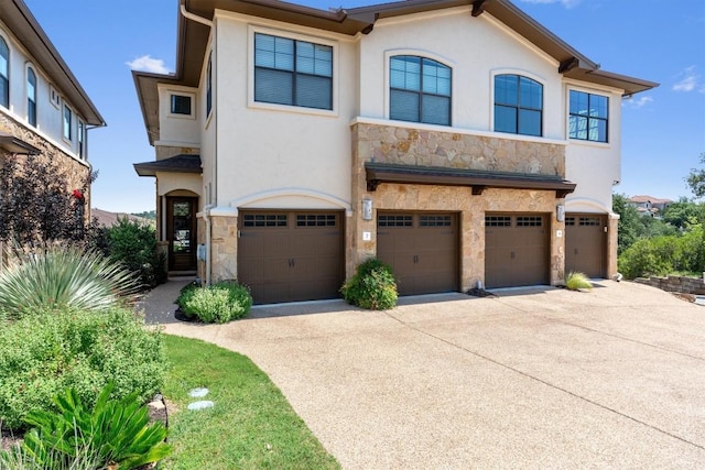 4000 Ranch Road 620 N Unit 7, Austin, TX 78734 - view of front of property featuring stone siding, a garage, stucco siding, and driveway