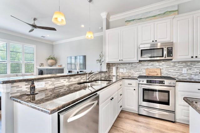 4000 Ranch Road 620 N Unit 7, Austin, TX 78734 - kitchen with stainless steel appliances, a sink, a peninsula, backsplash, and white cabinets
