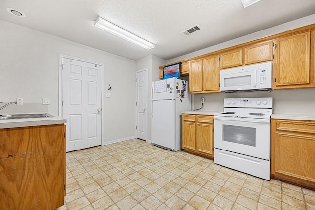 308 Janelle Drive A And B, Copperas Cove, TX 76522 - kitchen featuring white appliances, light countertops, a textured ceiling, and brown cabinets