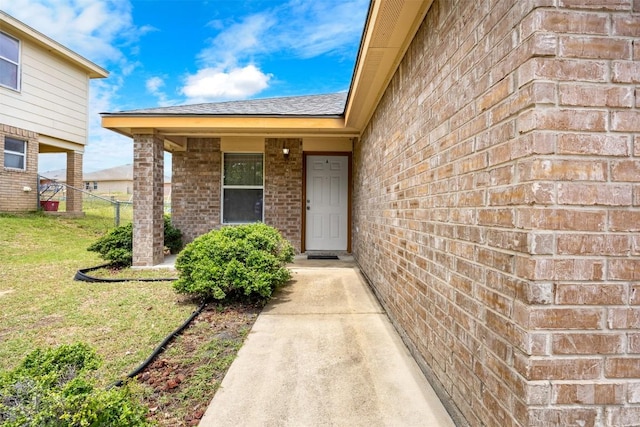 308 Janelle Drive A And B, Copperas Cove, TX 76522 - doorway to property featuring brick siding, a yard, and a shingled roof