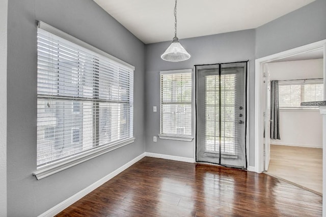 2320 Gracy Farms Ln Unit 1024, Austin, TX 78758 - unfurnished dining area featuring healthy amount of natural light, wood finished floors, and baseboards