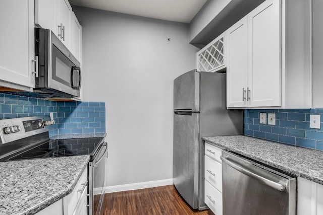 2320 Gracy Farms Ln Unit 1024, Austin, TX 78758 - kitchen featuring stainless steel appliances, baseboards, dark wood-style flooring, light stone countertops, and white cabinetry