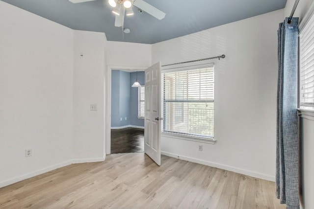 2320 Gracy Farms Ln Unit 1024, Austin, TX 78758 - empty room featuring a ceiling fan, light wood-type flooring, baseboards, and plenty of natural light