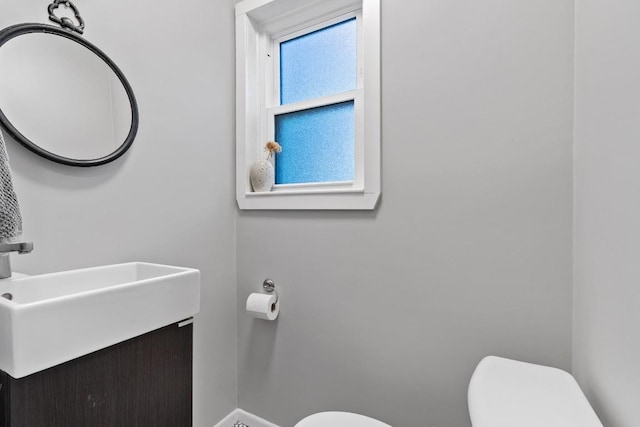 5205 Buffalo Pass, Austin, TX 78745 - bathroom with toilet, vanity, and baseboards