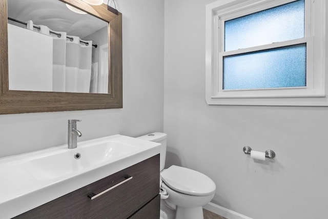 5205 Buffalo Pass, Austin, TX 78745 - full bathroom with toilet, vanity, curtained shower, and baseboards