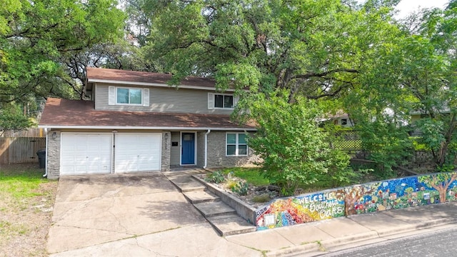 5205 Buffalo Pass, Austin, TX 78745 - traditional home featuring concrete driveway, an attached garage, and stone siding