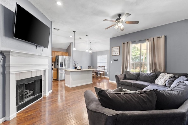 2000 Holly Springs Dr, Taylor, TX 76574 - living room with a ceiling fan, wood finished floors, lofted ceiling, recessed lighting, and a tiled fireplace