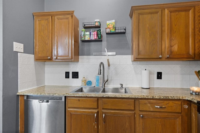 2000 Holly Springs Dr, Taylor, TX 76574 - kitchen with stainless steel dishwasher, decorative backsplash, brown cabinetry, and light stone countertops