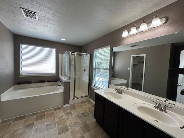 125 Lilly Crk, Boerne, TX 78006 - full bath with a textured ceiling, a stall shower, a garden tub, healthy amount of natural light, and double vanity