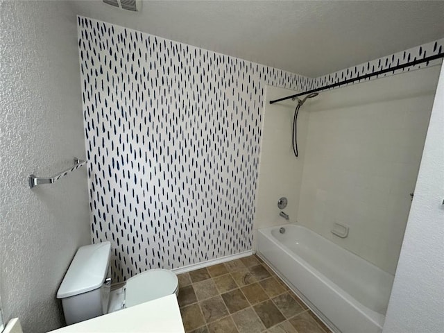 125 Lilly Crk, Boerne, TX 78006 - bathroom with toilet, shower / tub combination, baseboards, and stone finish flooring