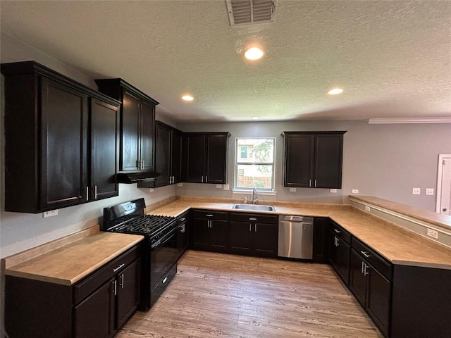 125 Lilly Crk, Boerne, TX 78006 - kitchen featuring dishwasher, black gas stove, a sink, a textured ceiling, and a peninsula
