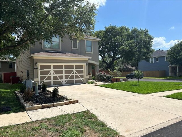 125 Lilly Crk, Boerne, TX 78006 - view of front facade with driveway, a garage, stucco siding, and a front lawn