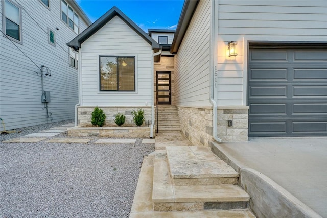 property entrance with stone siding and an attached garage