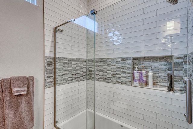full bathroom featuring bath / shower combo with glass door