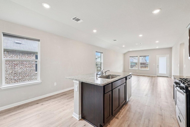 136 Ellinger Rd, Georgetown, TX 78626 - kitchen with a sink, stainless steel appliances, light wood-type flooring, light stone countertops, and recessed lighting
