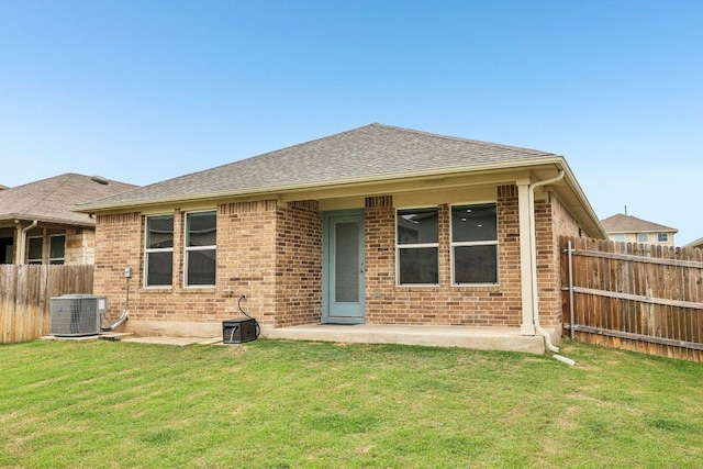136 Ellinger Rd, Georgetown, TX 78626 - back of house with cooling unit, brick siding, roof with shingles, and a patio