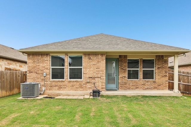 136 Ellinger Rd, Georgetown, TX 78626 - rear view of house featuring central air condition unit, brick siding, a shingled roof, and a patio