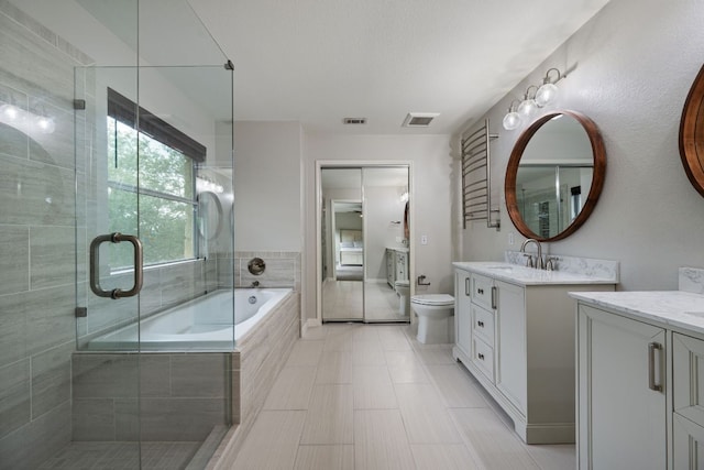 4308 Canyon Glen Cir, Austin, TX 78732 - full bath with two vanities, a shower stall, a bath, toilet, and tile patterned floors