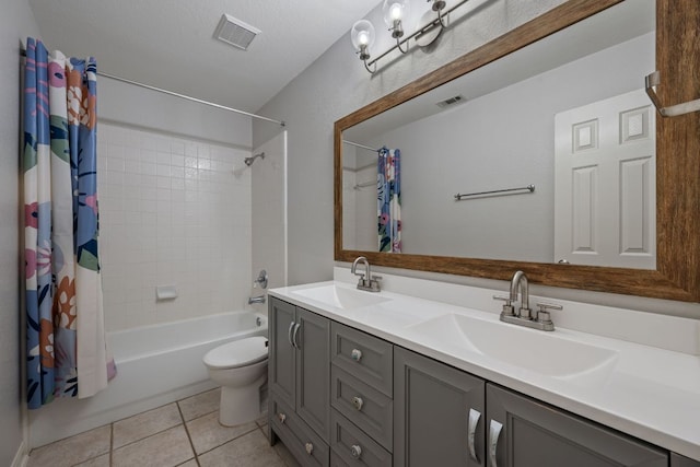 4308 Canyon Glen Cir, Austin, TX 78732 - bathroom with double vanity, shower / bath combo with shower curtain, tile patterned flooring, and toilet