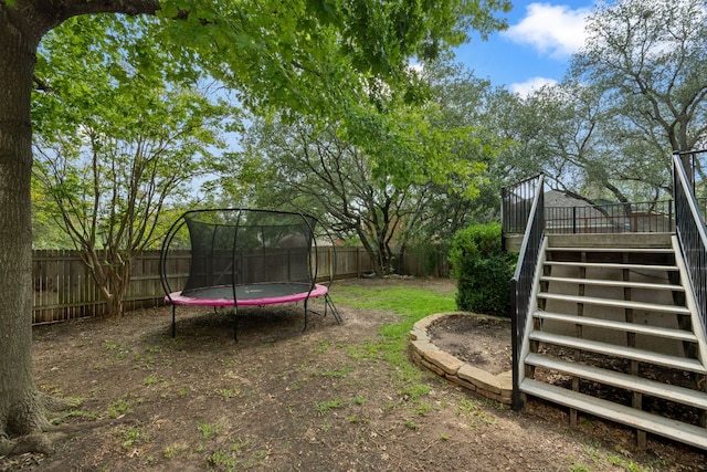 4308 Canyon Glen Cir, Austin, TX 78732 - fenced backyard featuring stairs, a trampoline, and a wooden deck