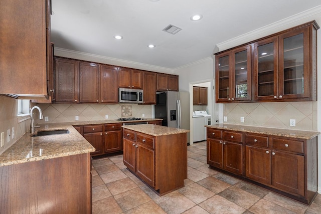 4308 Canyon Glen Cir, Austin, TX 78732 - kitchen with a sink, appliances with stainless steel finishes, crown molding, backsplash, and light stone countertops