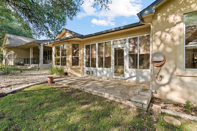 206 Whispering Wind Dr, Georgetown, TX 78633 - rear view of property featuring a patio, stucco siding, and a sunroom