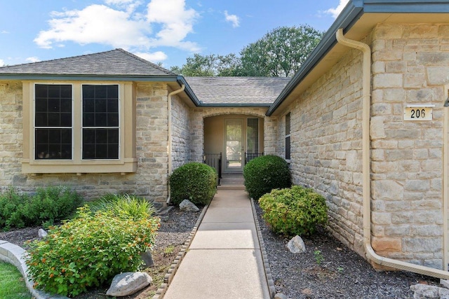 206 Whispering Wind Dr, Georgetown, TX 78633 - entrance to property featuring stone siding and a shingled roof