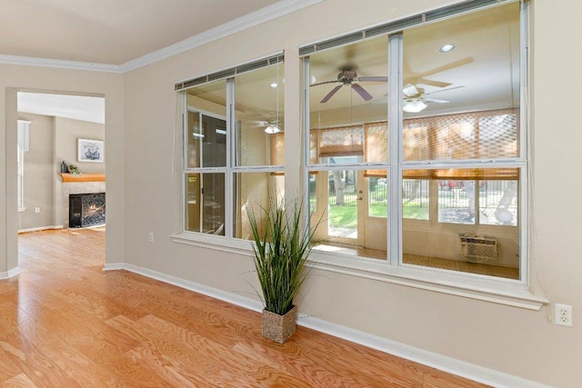 206 Whispering Wind Dr, Georgetown, TX 78633 - detailed view of a ceiling fan, crown molding, wood finished floors, a tiled fireplace, and cooling unit