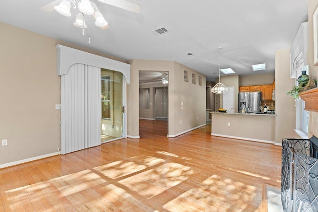 206 Whispering Wind Dr, Georgetown, TX 78633 - unfurnished living room featuring ceiling fan, light wood-style flooring, and baseboards