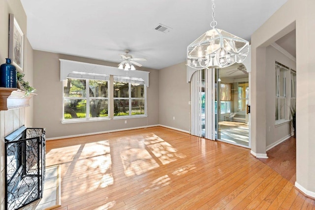 206 Whispering Wind Dr, Georgetown, TX 78633 - unfurnished dining area featuring ceiling fan, a chandelier, hardwood / wood-style flooring, and baseboards