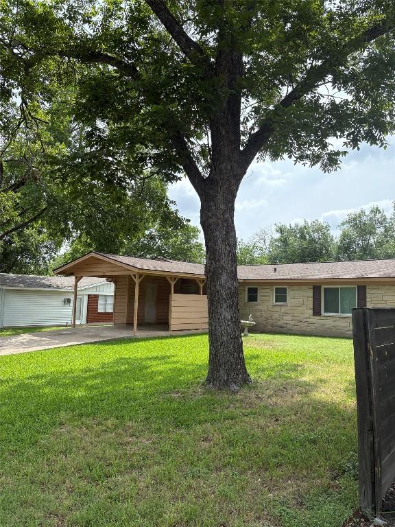 5907 Eureka Dr, Austin, TX 78745 - ranch-style home featuring a front yard, driveway, stone siding, and an attached carport