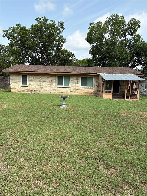 5907 Eureka Dr, Austin, TX 78745 - rear view of property featuring a lawn and stone siding
