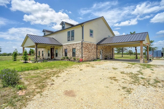 626 Sparta Field Rd, Waelder, TX 78959 - rear view of house featuring dirt driveway, a metal roof, an attached carport, and a yard