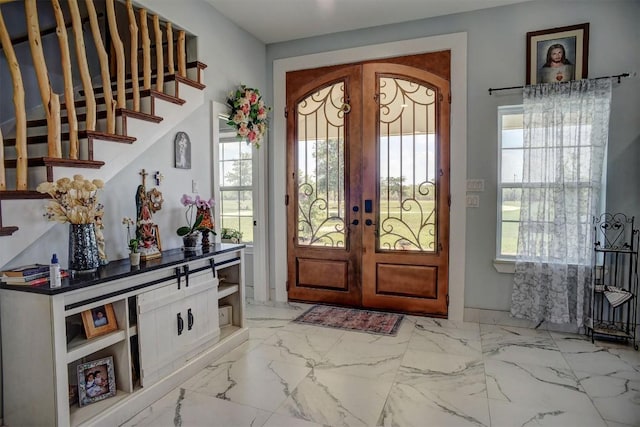 626 Sparta Field Rd, Waelder, TX 78959 - entryway with french doors, marble look tiles, and stairs