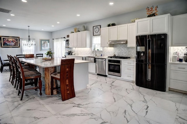 626 Sparta Field Rd, Waelder, TX 78959 - kitchen featuring stainless steel appliances, under cabinet range hood, light countertops, backsplash, and recessed lighting