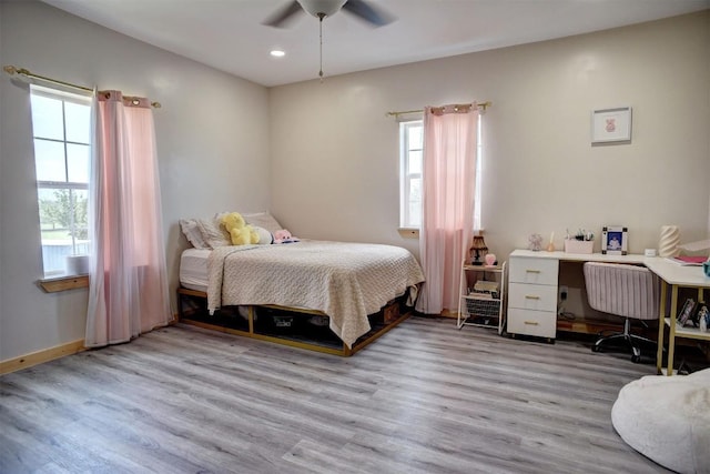 626 Sparta Field Rd, Waelder, TX 78959 - bedroom with multiple windows, wood finished floors, recessed lighting, and a ceiling fan