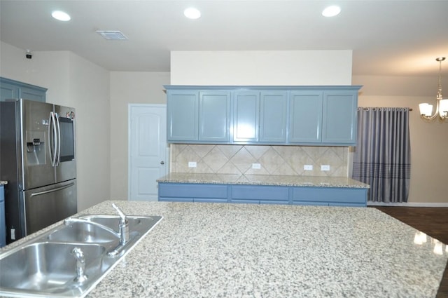 11024 Night Camp Dr, Austin, TX 78754 - kitchen featuring stainless steel fridge with ice dispenser, a sink, a chandelier, decorative backsplash, and dark wood-style floors