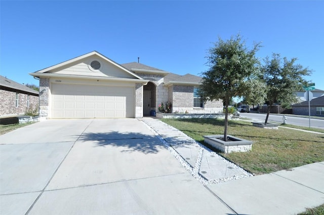 11024 Night Camp Dr, Austin, TX 78754 - ranch-style house featuring concrete driveway, a garage, a front lawn, and brick siding