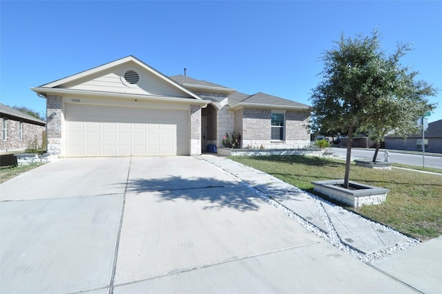 11024 Night Camp Dr, Austin, TX 78754 - single story home with concrete driveway, a garage, stone siding, and a front yard