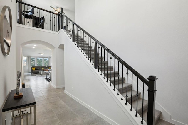 8119 Purple Aster Pass, Leander, TX 78645 - staircase with arched walkways, ceiling fan, and a high ceiling