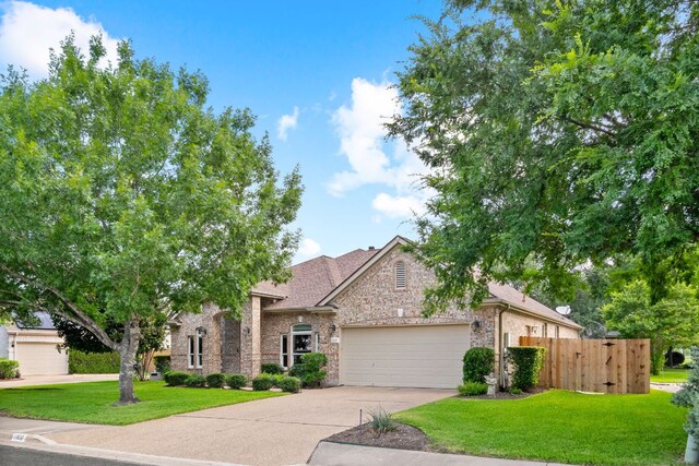 11037 River Plantation Dr, Austin, TX 78747 - view of front facade featuring a garage, concrete driveway, brick siding, roof with shingles, and stone siding