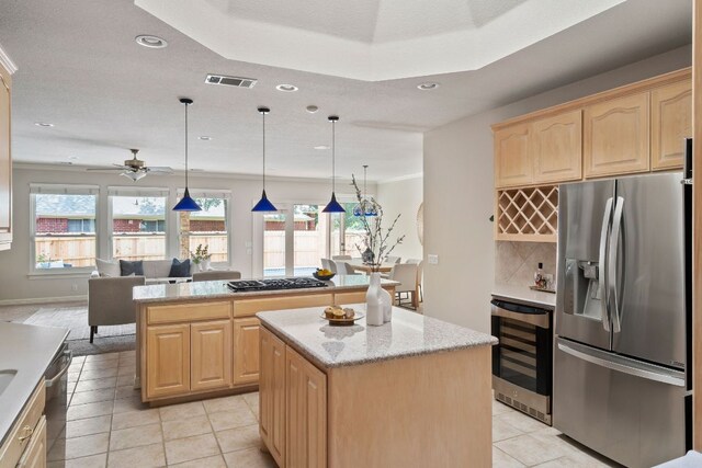11037 River Plantation Dr, Austin, TX 78747 - kitchen with appliances with stainless steel finishes, beverage cooler, a center island, light brown cabinetry, and recessed lighting